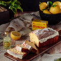 Sliced lemon drizzle loaf cake showing moist lemon sponge