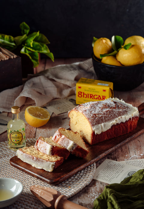 Sliced lemon drizzle loaf cake showing moist lemon sponge