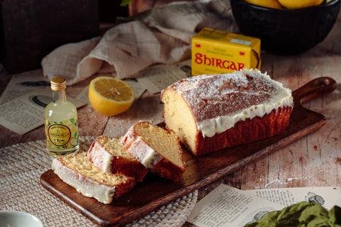 Sliced lemon drizzle loaf cake showing moist lemon sponge